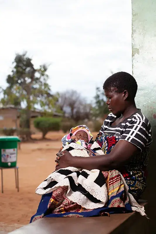 Young woman holding baby