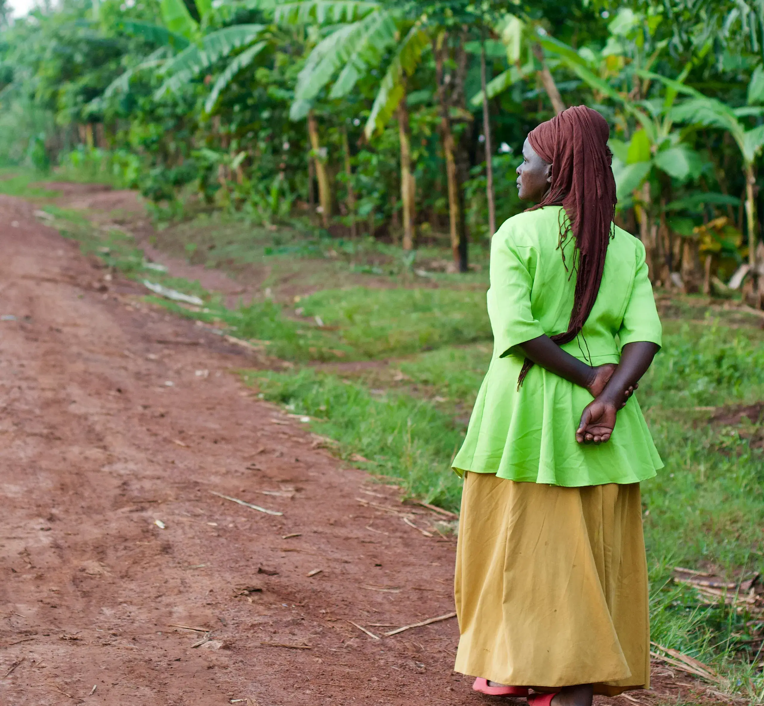 Woman walking outside near trees