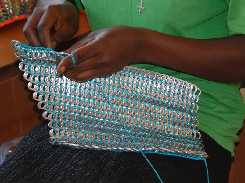 Young woman sewing a pop tab project