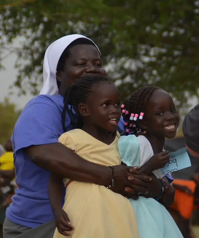 Sister Rosemary and two young girls smiling