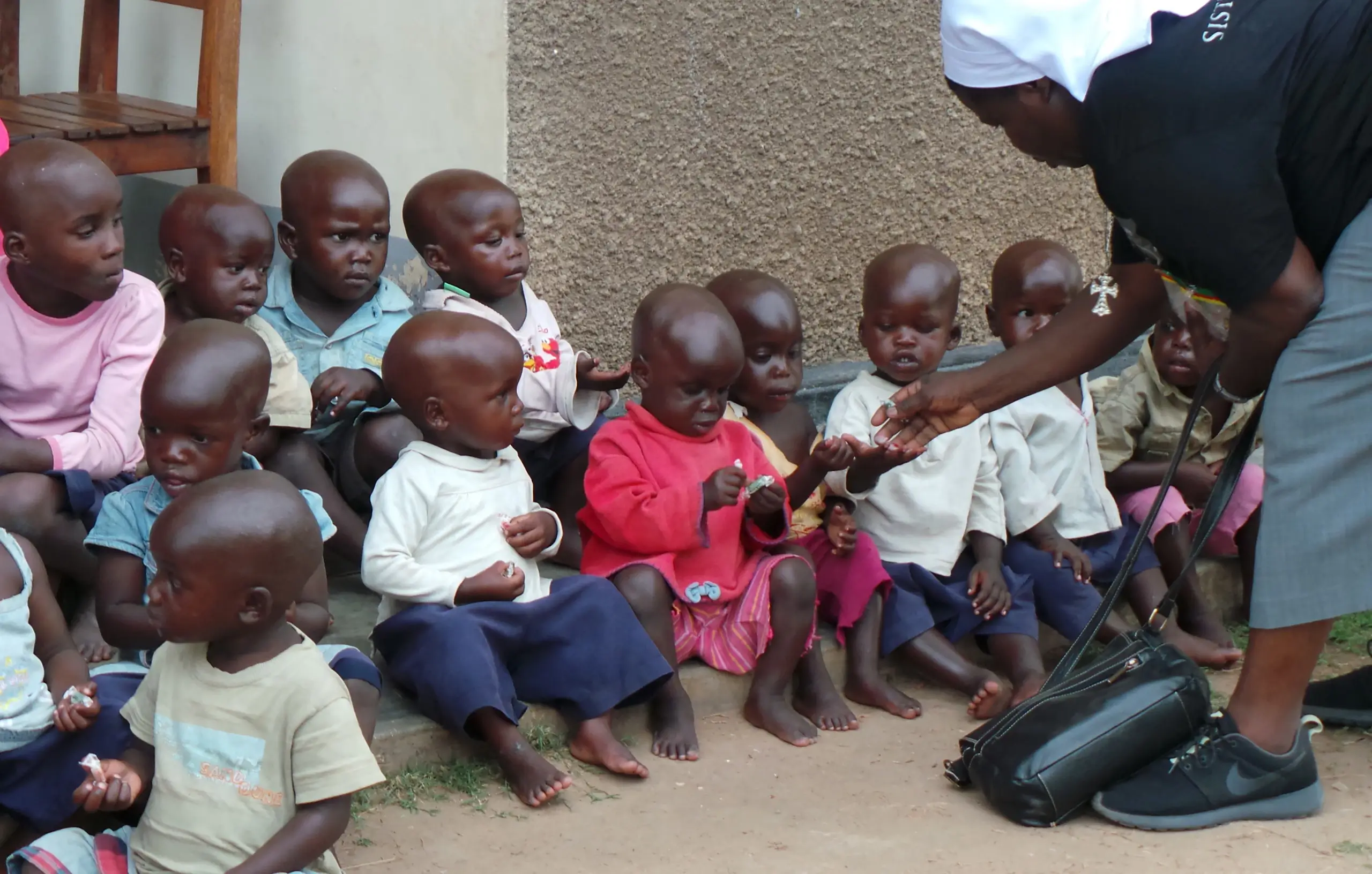 Sister Rosemary giving snacks to children