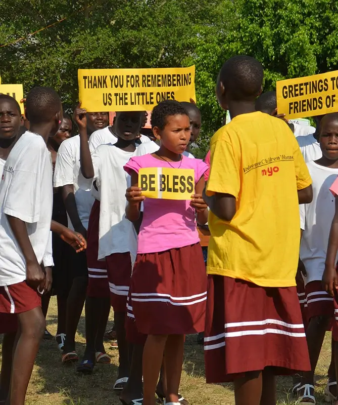 Children holding signs thanking donors