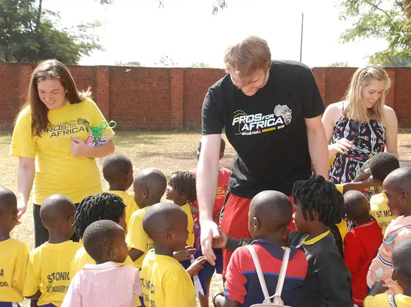 Volunteers talking to children at St. Monica's 