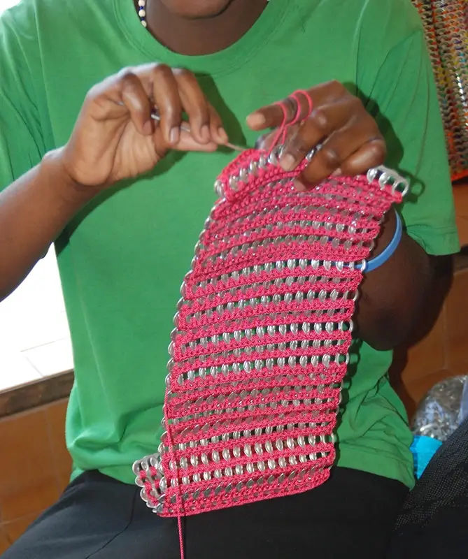 Young woman sewing pop tab project